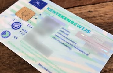 Groen kentekenbewijs die op tafel ligt.