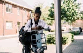 Jonge fietser kijkt op haar telefoon