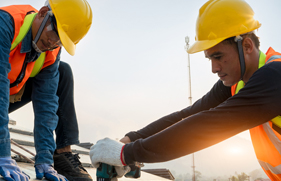 2 mannen met helm op aan het werk in de bouw